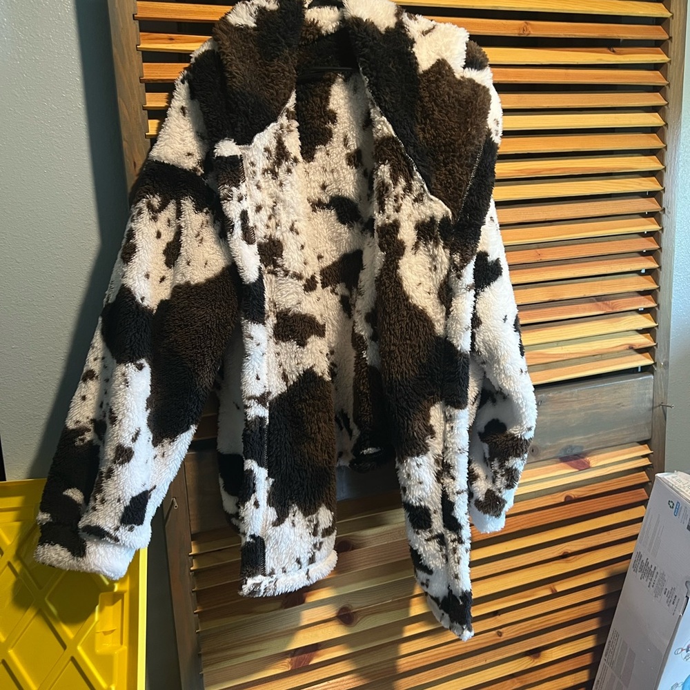 Two Temu jackets, one cow print and one tribel